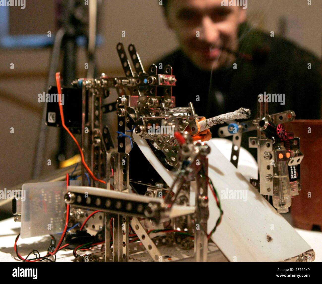 A visitor looks at the "Bic-o-mat" made by Adrian Dabrowski of Austria, one of around 30 robots at Vienna's annual Roboexotica December 7, 2006, which showcases how home-built machines deal with the modern pastime of hanging out in bars. Picture taken December 7, 2006. TO ACCOMPANY STORY AUSTRIA-ROBOTS/ REUTERS/Herwig Prammer (AUSTRIA) Stock Photo