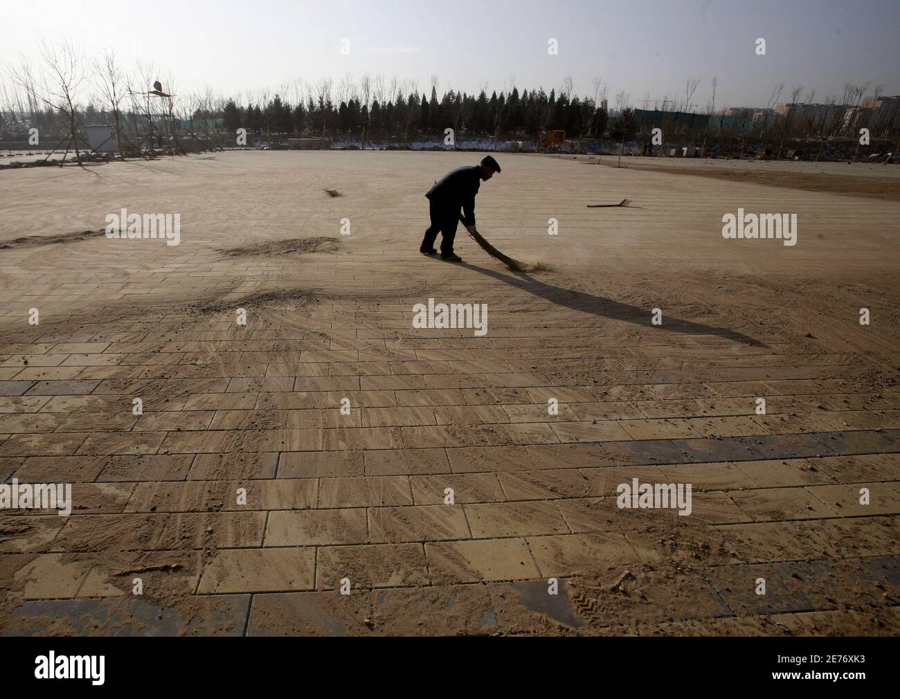 A Worker Sweeps Dirt Off New Tiles At The Olympic Green Hockey Field In Beijing December 14 07 Beijing Wary Of It S Clean Air Target Before Next Year S Olympic Games Has Poured