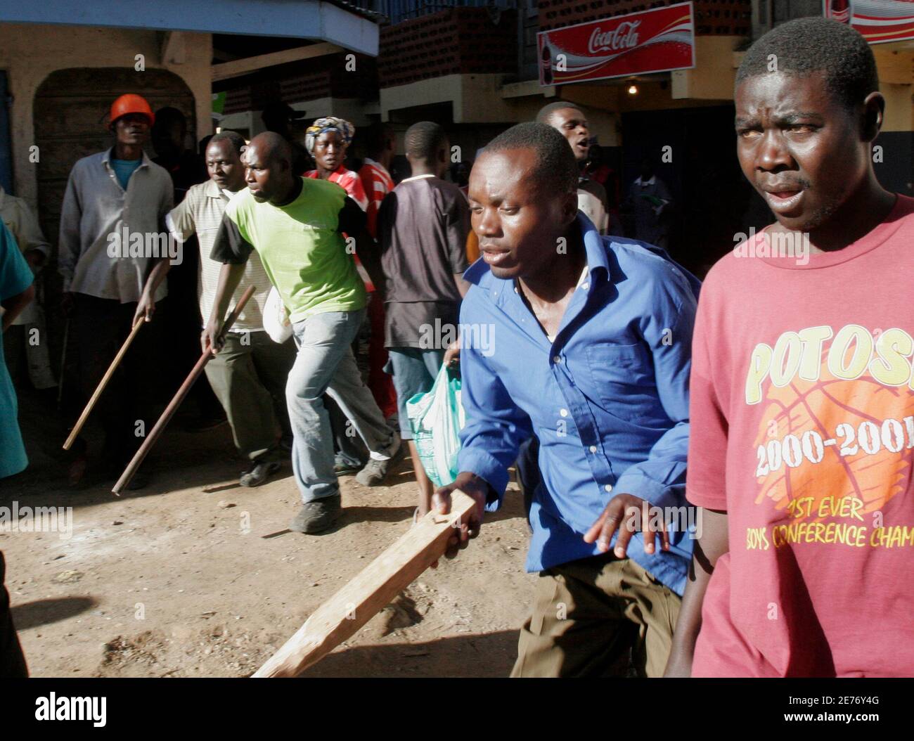 Opposition supporters run armed with sticks during ethnic violence in Nairobi January 2, 2008. President Mwai Kibaki's government accused rival Raila Odinga's party of unleashing 'genocide' in Kenya on Wednesday as the death toll from tribal violence over a disputed election passed 300. REUTERS/Thomas Mukoya   (KENYA) Stock Photo