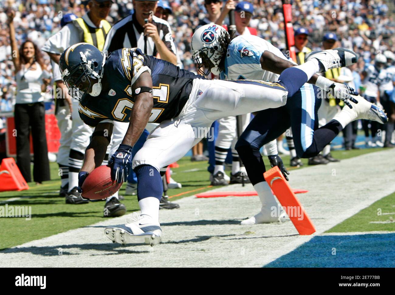 San Diego Chargers running back LaDainian Tomlinson (L) scores his second touchdown of the first half as he gets past Tennessee Titans' Reynaldo Hill during NFL football action in San Diego, California September  17, 2006.     REUTERS/Mike Blake   (UNITED STATES) Stock Photo
