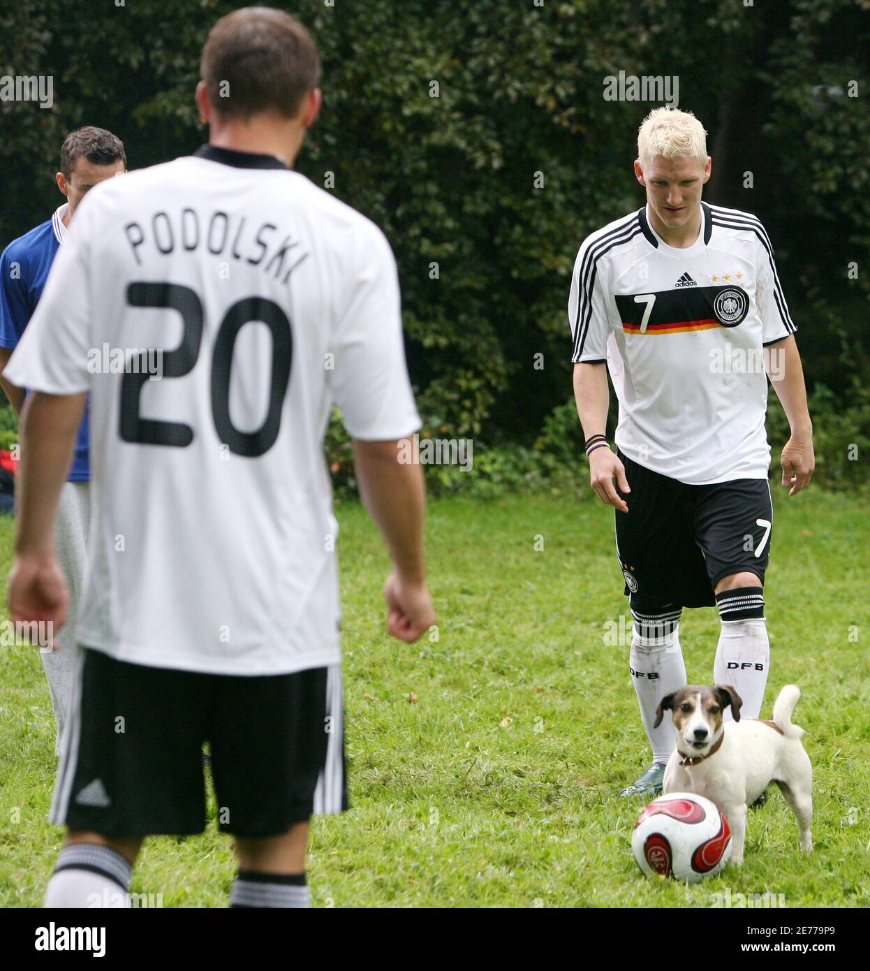 German national soccer team players Lukas Podolski (L) Bastian  Schweinsteiger wearing the official Euro 2008 German team shirt, and film  dog Jackie, film a TV commercial for Adidas and the German Soccer