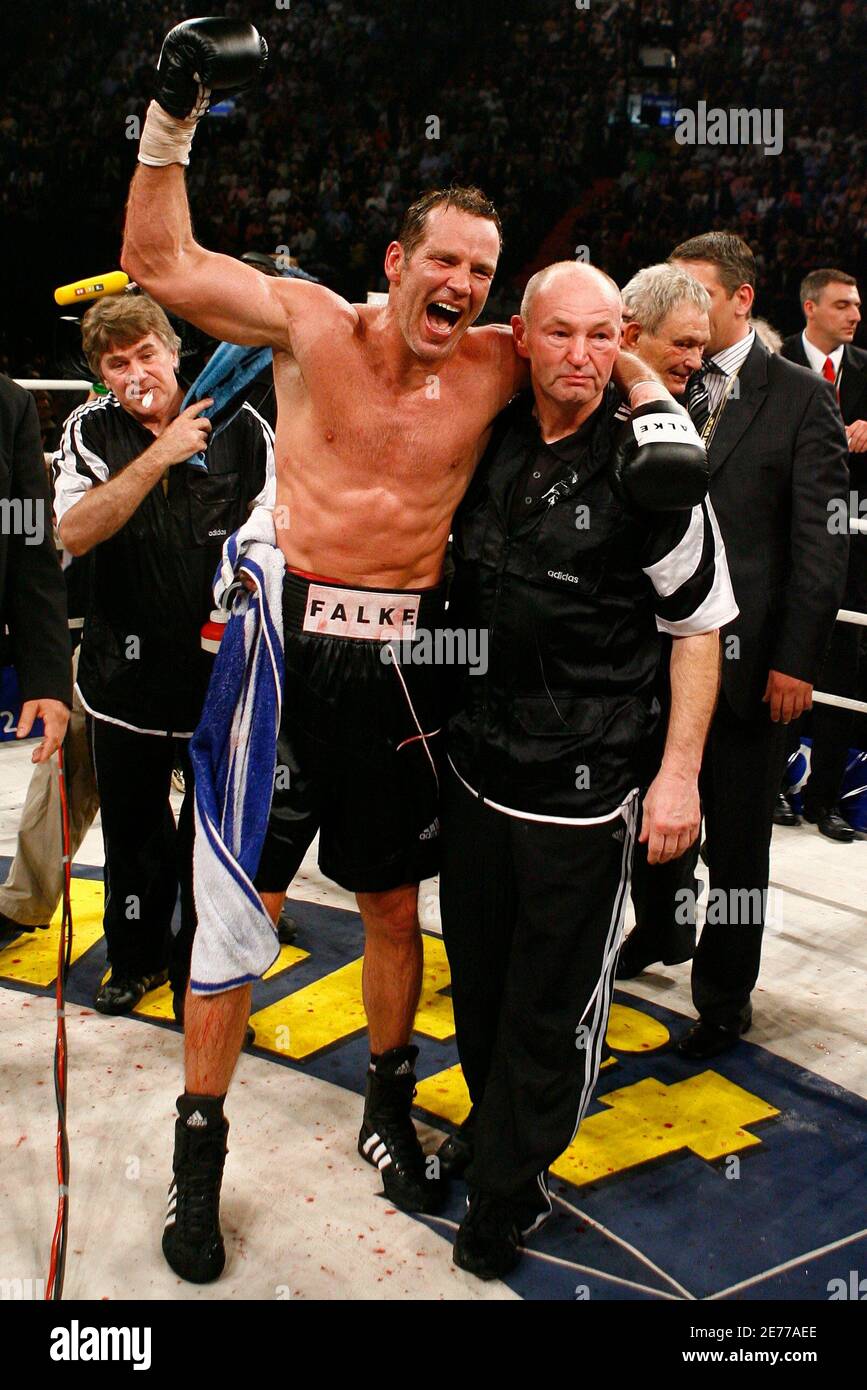 Germany's Henry Maske celebrates with his Manfred Wolke after defeating Virgil Hill from the U.S. after their cruiser weight fight, a of their Championship ten years ago, in