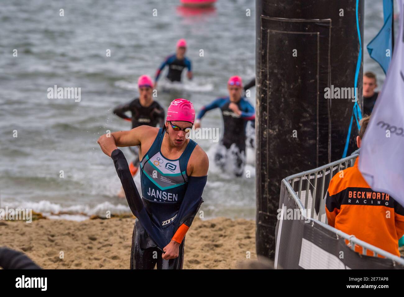 Melbourne, Australia. 17th Jan, 2021. Tomm Jansen - Junior Elite removing the wet suit on a run during the 2XU Triathlon Series 2021, Race 1 at St Kilda Beach. Credit: SOPA Images Limited/Alamy Live News Stock Photo