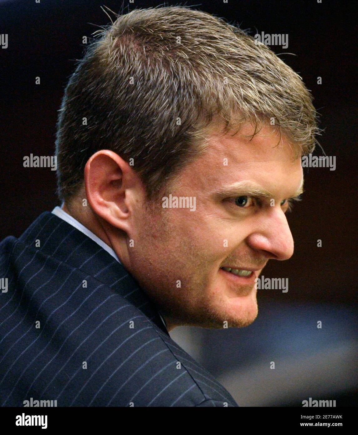U.S. cyclist Floyd Landis looks to one of his attorneys at an arbitration hearing in Malibu, California May 21, 2007. The arbitrators are considering a case brought against Landis by the U.S. Anti-Doping Agency alleging the cyclist used illicit performance-enhancing drugs. He faces a possible two-year suspension and loss of his Tour de France title. REUTERS/Danny Moloshok (UNITED STATES) Stock Photo
