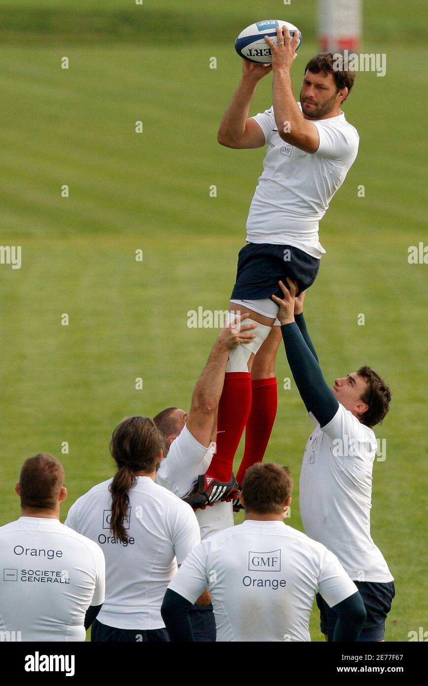 Captain of the French rugby union team Lionel Nallet (top) jumps to grab  the ball during a training session at the Rugby Union National Centre in  Marcoussis, south of Paris, November 4,