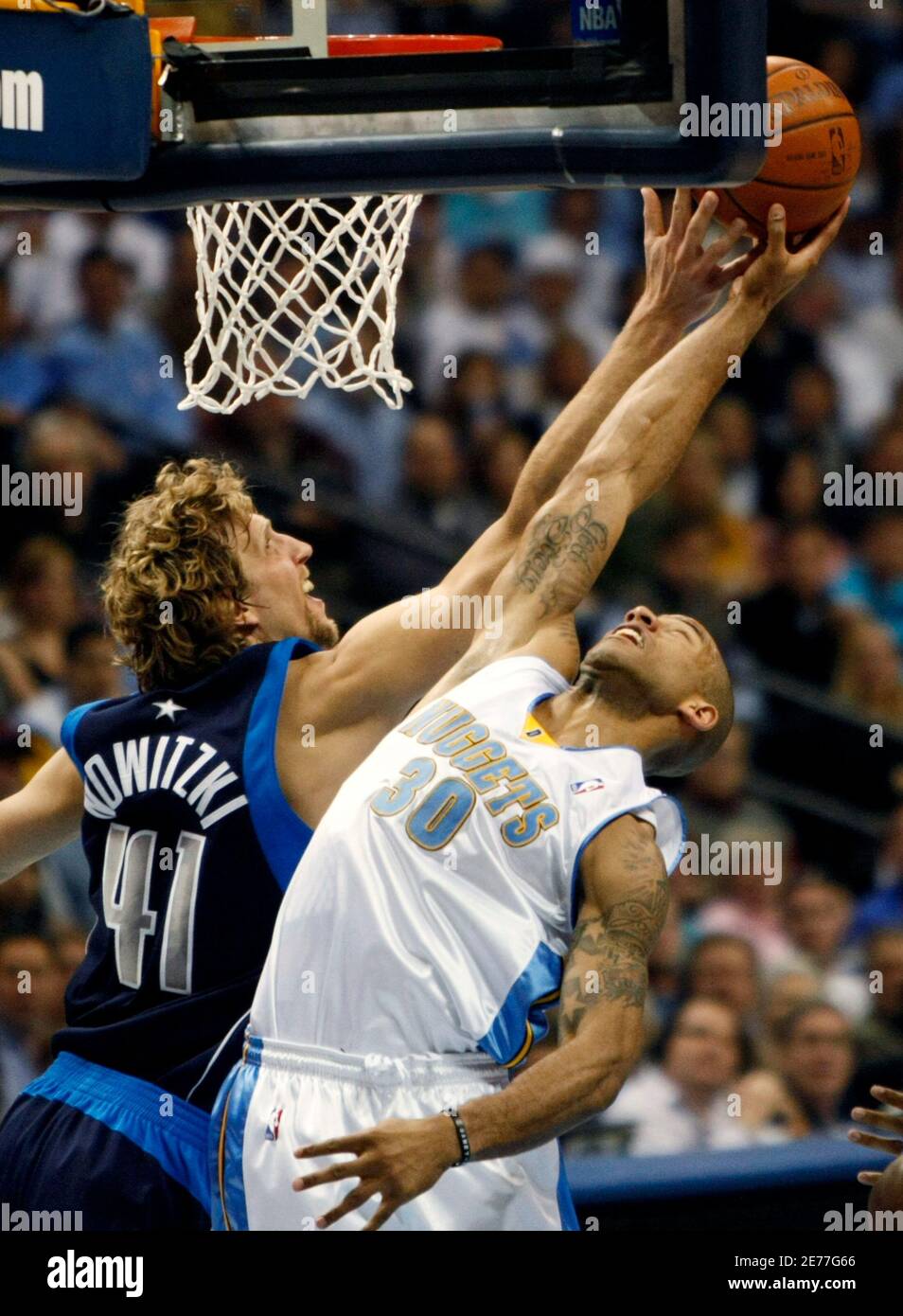 Denver Nuggets guard Dahntay Jones (R) has his shot blocked by Dallas Mavericks forward Dirk Nowitzki (L) in the first quarter of Game 1 of the NBA Western Conference semi-final basketball playoffs in Denver May 3, 2009.  REUTERS/Rick Wilking (UNITED STATES SPORT BASKETBALL) Stock Photo
