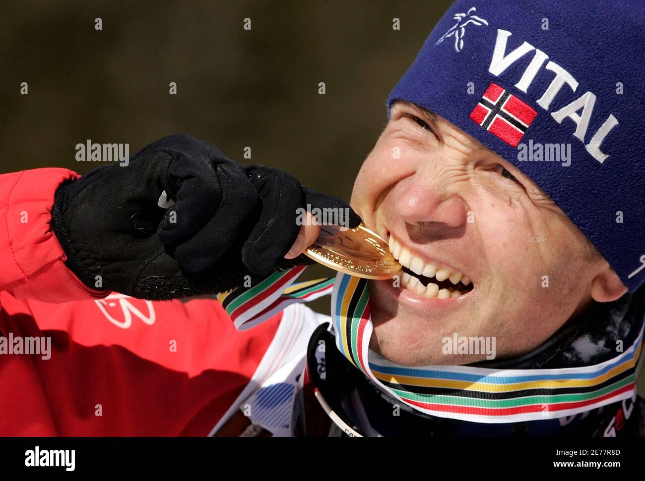World Champion Ole Einar Bjoerndalen of Norway poses with his gold medal at  the end of the men's 10 km sprint race competition at the Biathlon World  Championship in the northern Italy