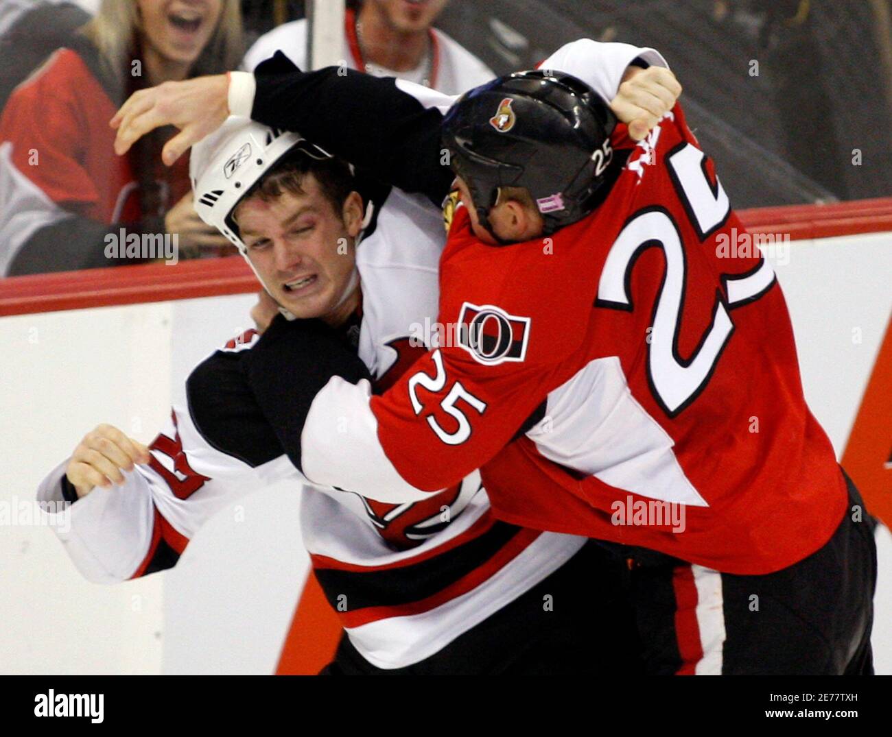 New Jersey Devils' David Clarkson (L) fights with Ottawa Senators' Chris Neil during the second period of their NHL hockey game in Ottawa October 8, 2007.        REUTERS/Chris Wattie   (CANADA) Stock Photo