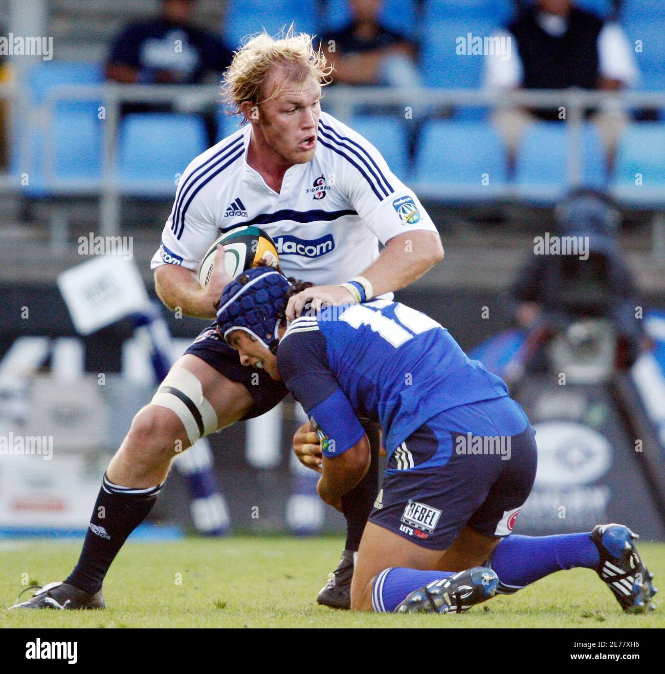 Schalk Burger (L) of the Stormers is tackled by Benson Stanley of the Blues  during the Super 14 rugby match at Eden Park in Auckland, March 22, 2008.  REUTERS/Nigel Marple (NEW ZEALAND