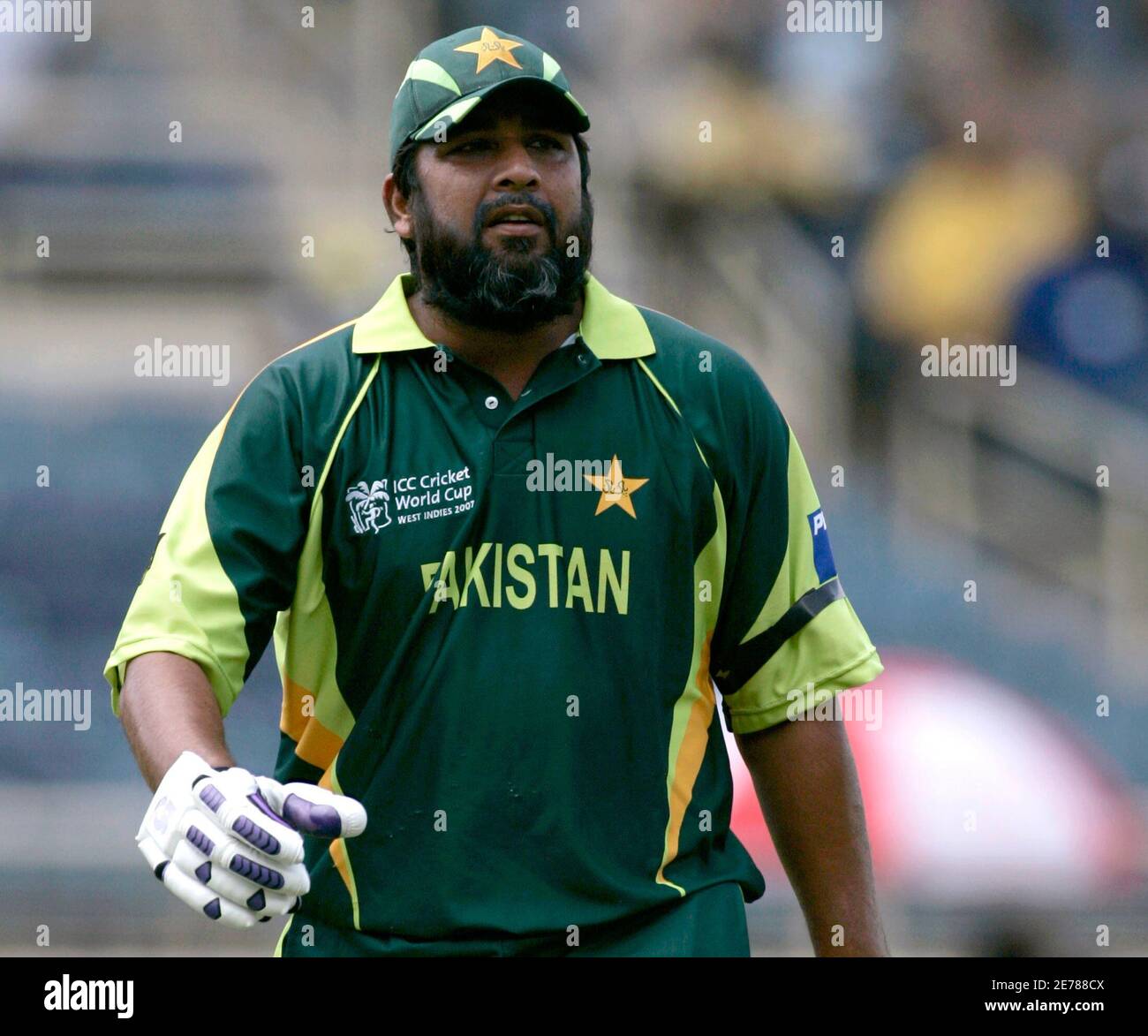 Pakistan captain Inzamam-ul-Haq walks off the pitch, wearing a black armband  in memory of coach Bob Woolmer, after he was dismissed in his last one-day  international (ODI) innings before retiring during their