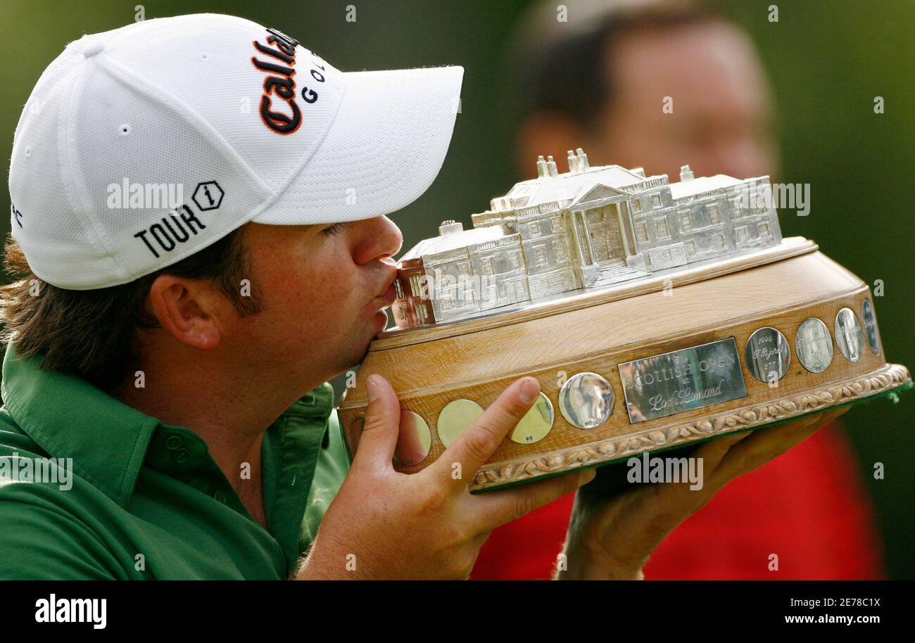 Northern Ireland's Graeme McDowell kisses the winners trophy after the final round of the Scottish Open golf tournament at Loch Lommond near Glasgow, Scotland July 13, 2008. REUTERS/David Moir (BRITAIN) Stock Photo