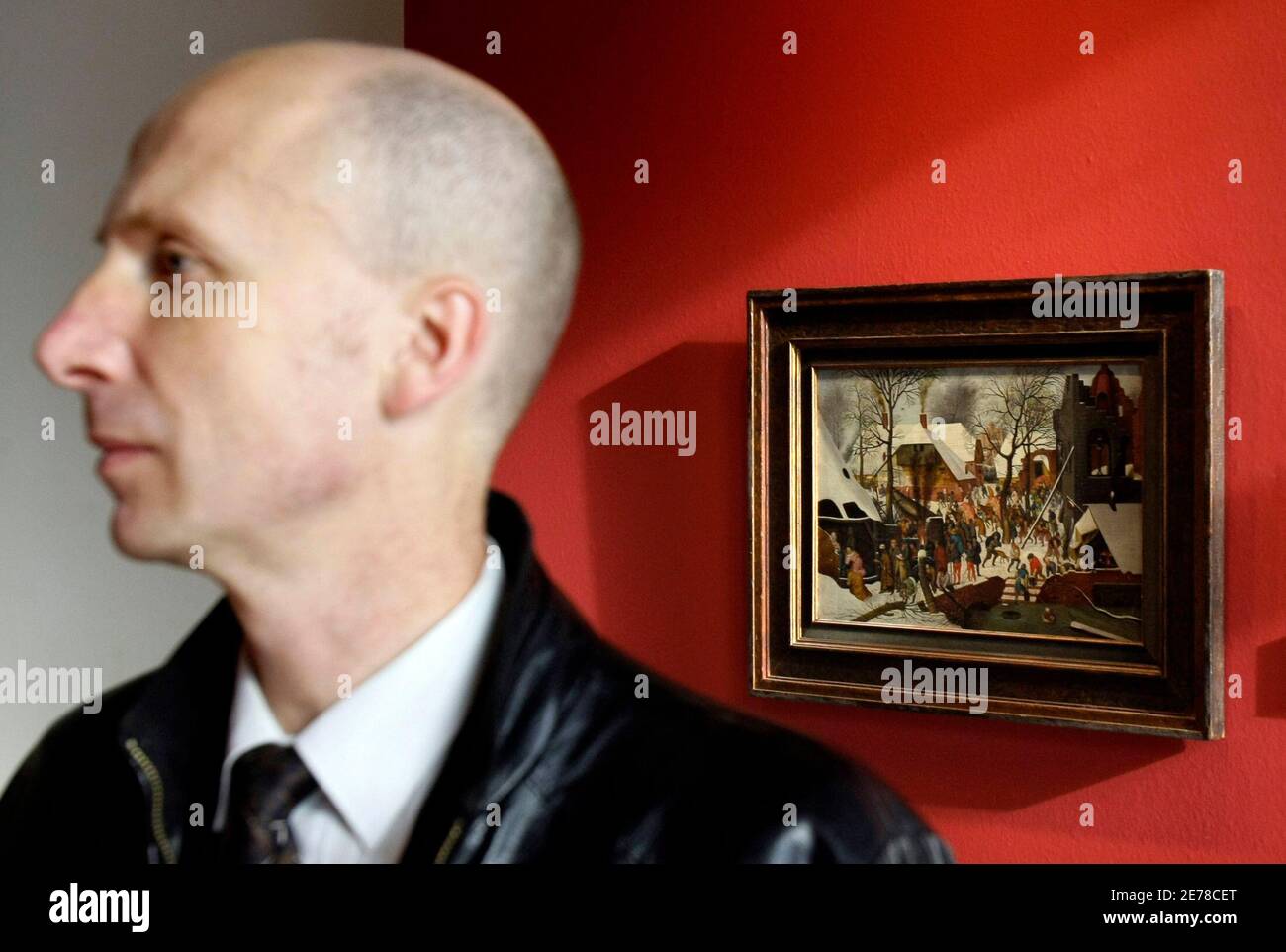 A man attends a Moscow exhibition of top lots to be auctioned by the Christie's fine art auction house, October 14, 2008. Lovers of expensive art still have cash to burn and will turn their multi-million dollar art pieces into investments as the financial crisis bites into savings and earnings, global auction houses said on Tuesday. The picture on display is Pieter Brueghel the Younger's 'Adoration of the Magi'. REUTERS/Denis Sinyakov  (RUSSIA) Stock Photo