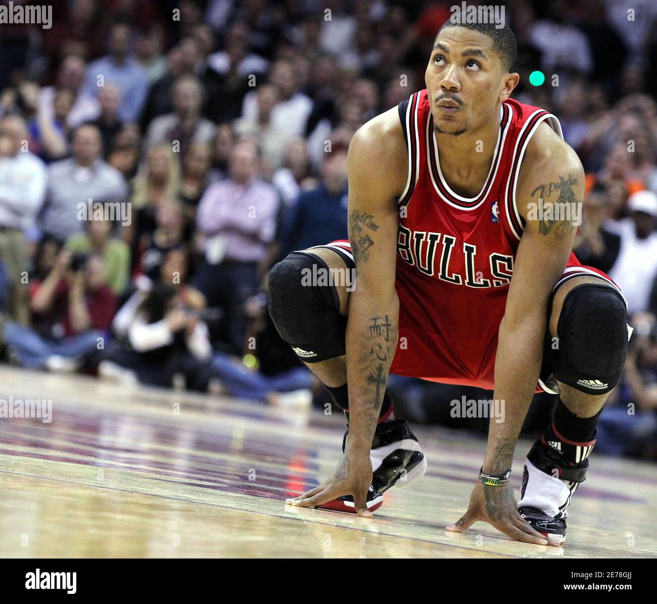 Chicago Bulls Derrick Rose squats down at midcourt during the last seconds  of fourth quarter of Game 5 of their NBA Eastern Conference playoff series  against the Cleveland Cavaliers in Cleveland, April