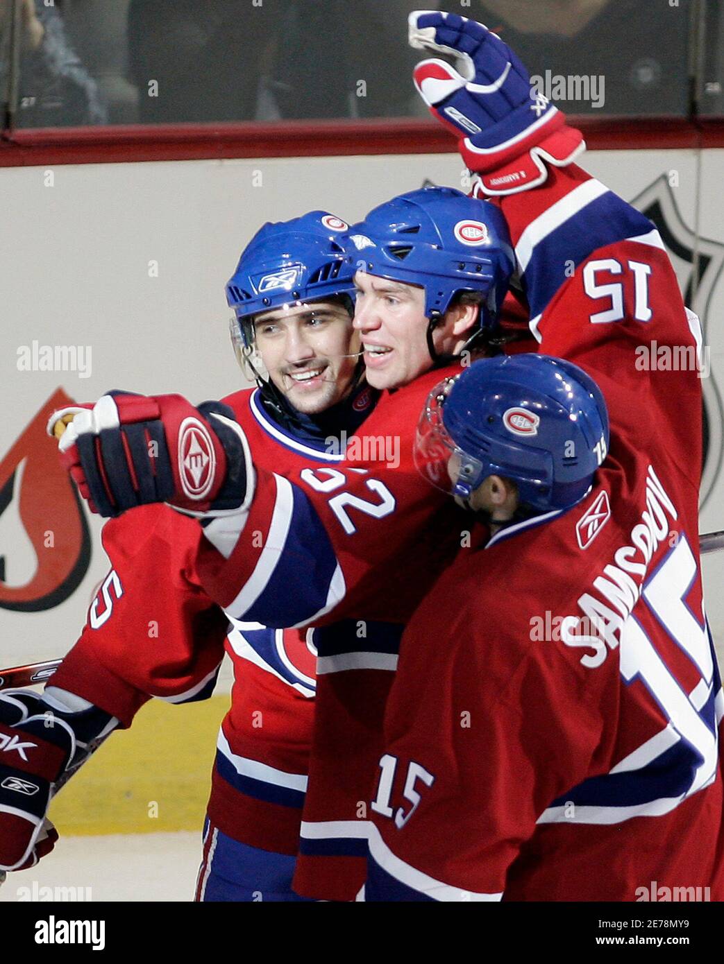 Montreal Canadiens Mathieu Dandenault (far L) celebrates his goal with  teammates Craig Rivet (C) and Sergei Samsonov (15) during first period NHL  action in Montreal, January 2, 2007. REUTERS/Christinne Muschi (CANADA Stock