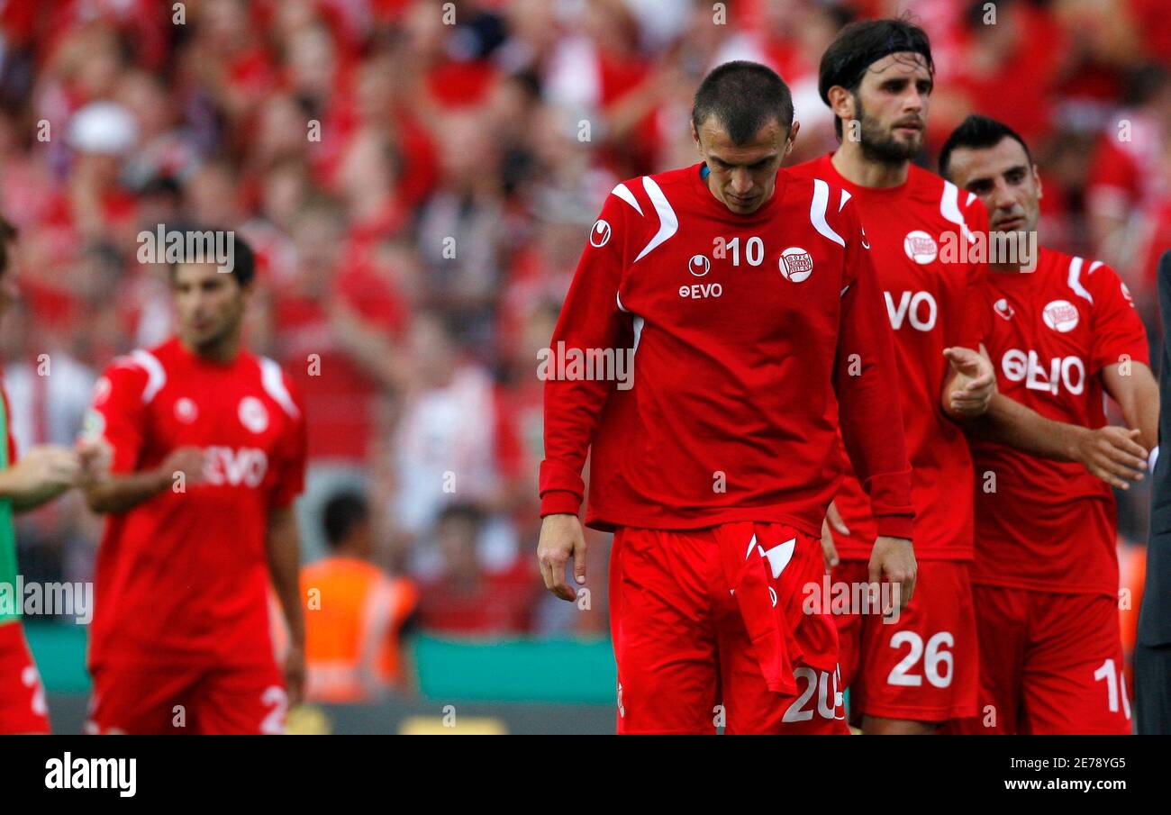Kickers Offenbach's Mirnes Mesic (L-R) Marko Kopilas, and Suat Tuerker  leave the pitch after losing their German soccer cup (DFB-Pokal) match  against Eintracht Frankfurt in Offenbach August 2, 2009. REUTERS/Johannes  Eisele (GERMANY