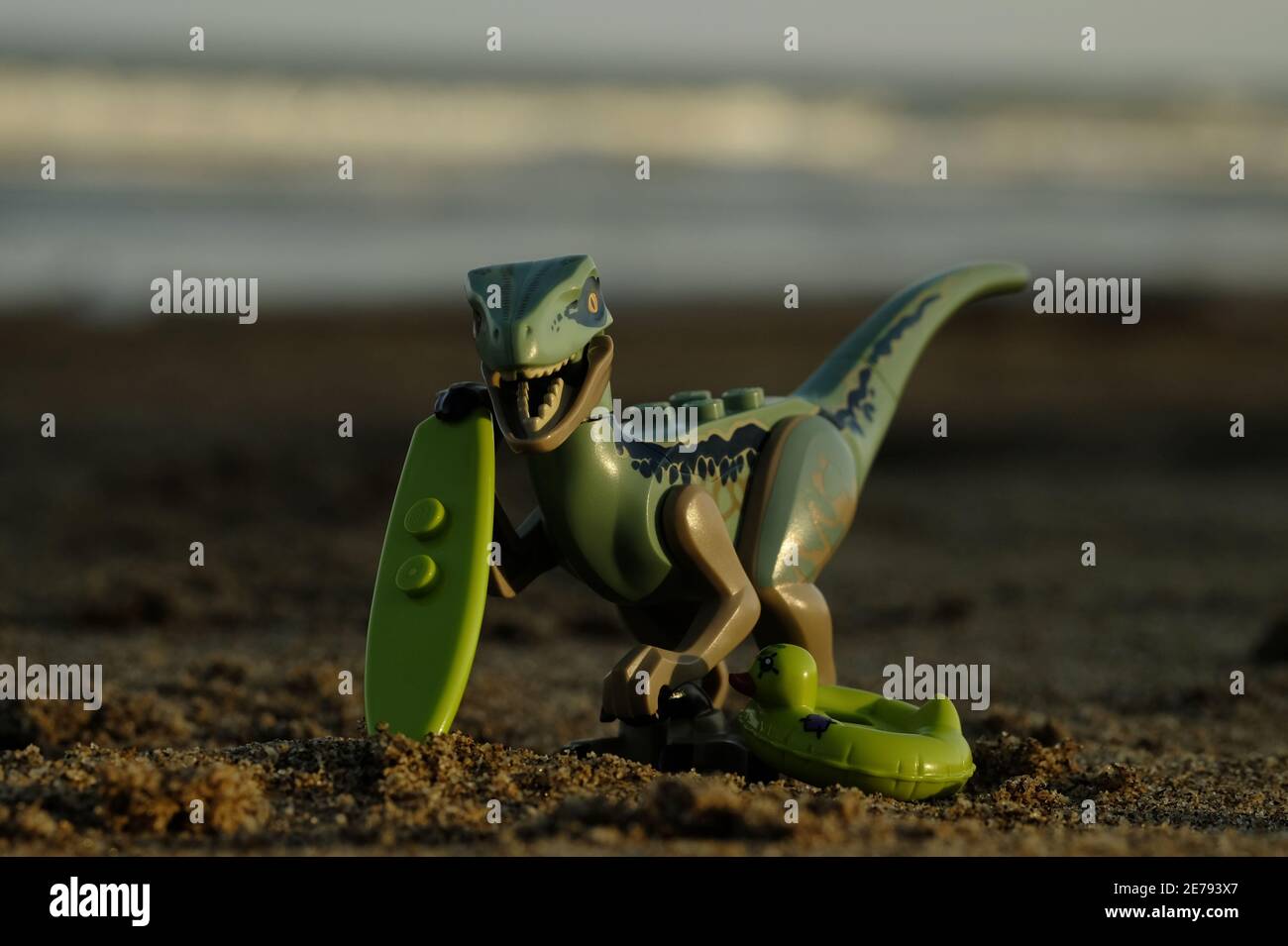 Indonesia, Sep 01 2018. Lego raptor on vacation, playing sand, swiming and surfing. Lego minifigures are manufactured by The Lego Group Stock Photo