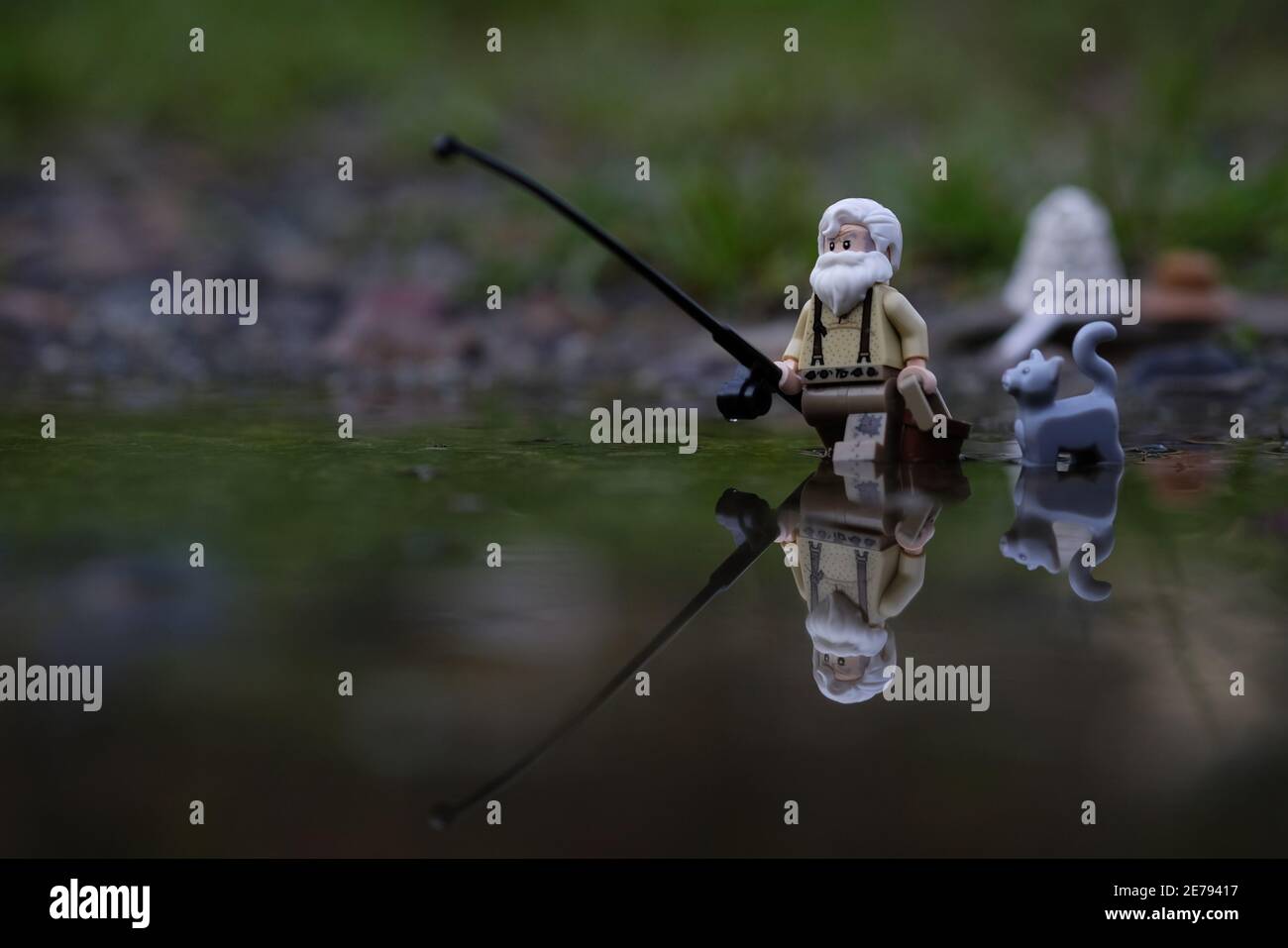 Indonesia, Oct 01 2018. Lego grandpa going fishing with his gray cat. Lego minifigures are manufactured by The Lego Group Stock Photo