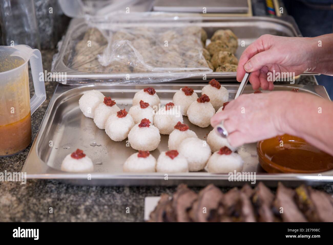 Nuremberg, Germany. 22nd Jan, 2021. Umeboshi on sushi rice balls are prepared for takeout at Mobile Culinary School for pre-ordered menus. Many restaurants are offering upscale menus for pickup during the lockdown. That includes Mobile Kochkunst in Nuremberg, which offers a weekend package every Friday that includes a salad, soup, main course with meat and sides, and a dessert. (to dpa 'Eating at the Lockdown - between cooking pleasure and frustration') Credit: Daniel Karmann/dpa/Alamy Live News Stock Photo