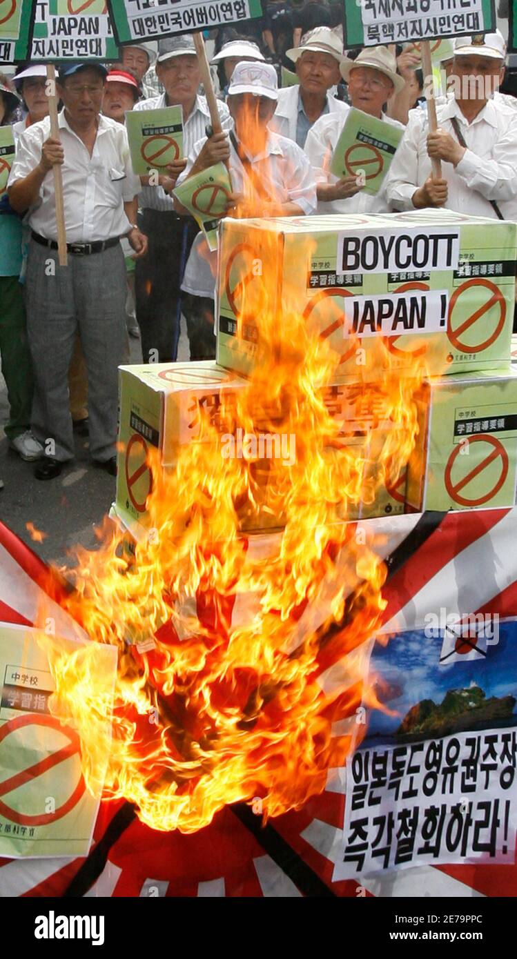 Protesters burn signs representing Japan's middle school teaching guide at a demonstration against Japan's sovereignty claim over a group of desolate volcanic islets Seoul and Pyongyang call Dokdo and Tokyo calls Takeshima, in front of Japanese embassy in Seoul July 15, 2008. South Korea's coastguard said on Tuesday it had stepped up patrols near the islands, a day after Seoul recalled its ambassador in anger at new Japanese claims to the rocky outcrops. On Monday, Tokyo said it had told Seoul that it would refer in a middle school teaching guide to the islands as Japanese territory. REUTERS/ Stock Photo