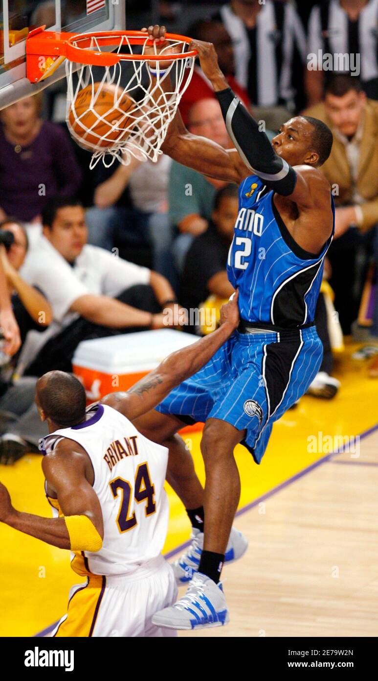 Dwight Howard (R) of the Orlando Magic dunks over Kobe Bryant of the Los  Angeles Lakers during Game 2 of the NBA Finals in Los Angeles, June 7,  2009. REUTERS/Danny Moloshok (UNITED
