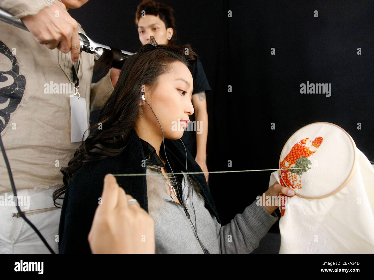 Model Anne Watanabe Daughter Of Actor Ken Watanabe Sews While Having Her Hair Done Backstage Before The Matthew Williamson Spring Summer 07 Ready To Wear Collection At The Singapore Fashion Festival In Singapore April 1