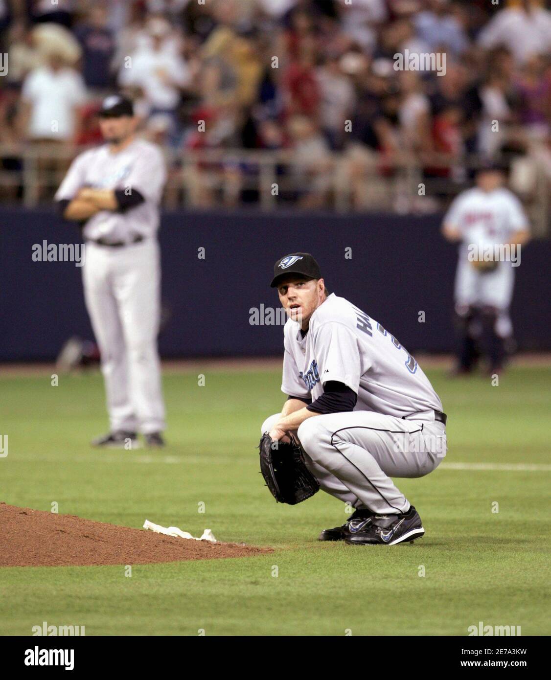 Toronto Blue Jays Starting Pitcher Roy Halladay C Squats Behind The Pitcher S Mound After Minnesota Twins Luis Castillo And Jason Bartlett Scored On A Wild Pitch During The Fifth Inning Of Their Toronto Blue Jays Starting Pitcher Roy Halladay C Squats Behind The Pitcher S Mound After Minnesota Twins Luis Castillo And Jason Bartlett Scored On A Wild Pitch During The Fifth Inning Of Their