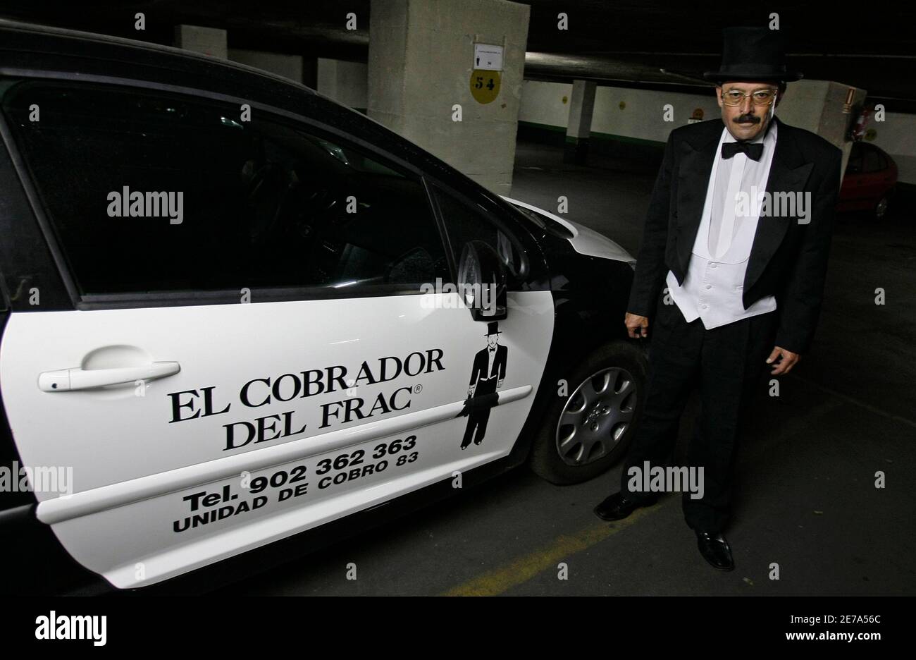 Manfred Gunther of the Spanish company The Cobrador del Frac (The Debt  Collector in Top Hat and Tails) poses near one of his company's vehicles in  Madrid August 12, 2008. If more