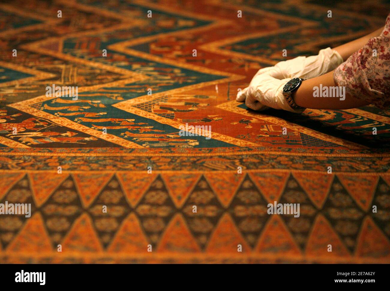 A Gallery Curator Prepares Batik Fabric For Display At The Peranakan Museum In Singapore April 25 2008 The Museum Which Opens In The City State On Saturday Is Touted As Having The World S