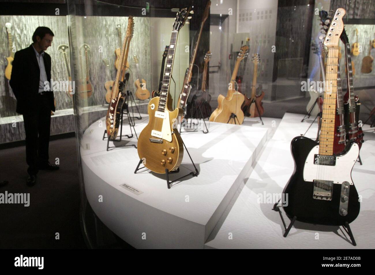 A 1955 Gibson Les Paul Goldtop guitar belonging to David Gilmour of Pink  Floyd (C) and a 1963 Fender Telecaster Custom guitar belonging to John  Lennon (R) are displayed at the "Travelling