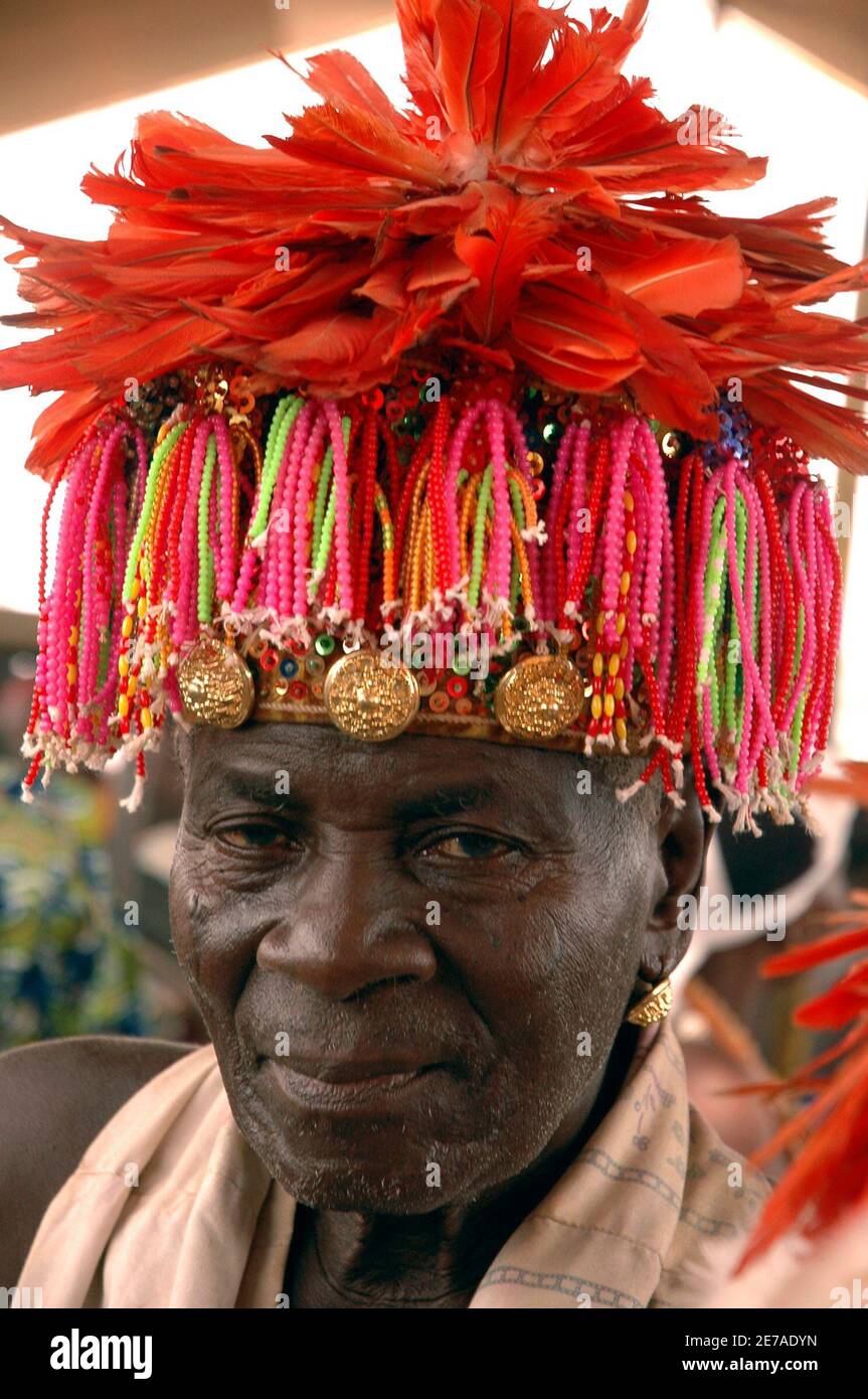 A voodoo priest wears a traditional hat 