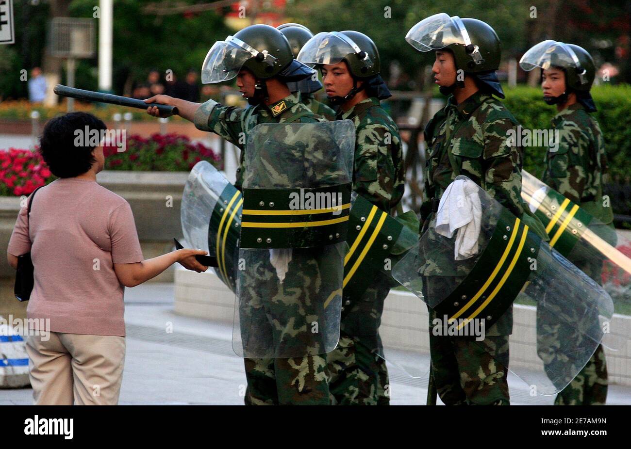 Chinese Paramilitary Police Wearing Riot Gear Tell A Woman To Move On As They Enforce A Curfew In The City Of Urumqi In China S Xinjiang Autonomous Region July 7 2009 China Said
