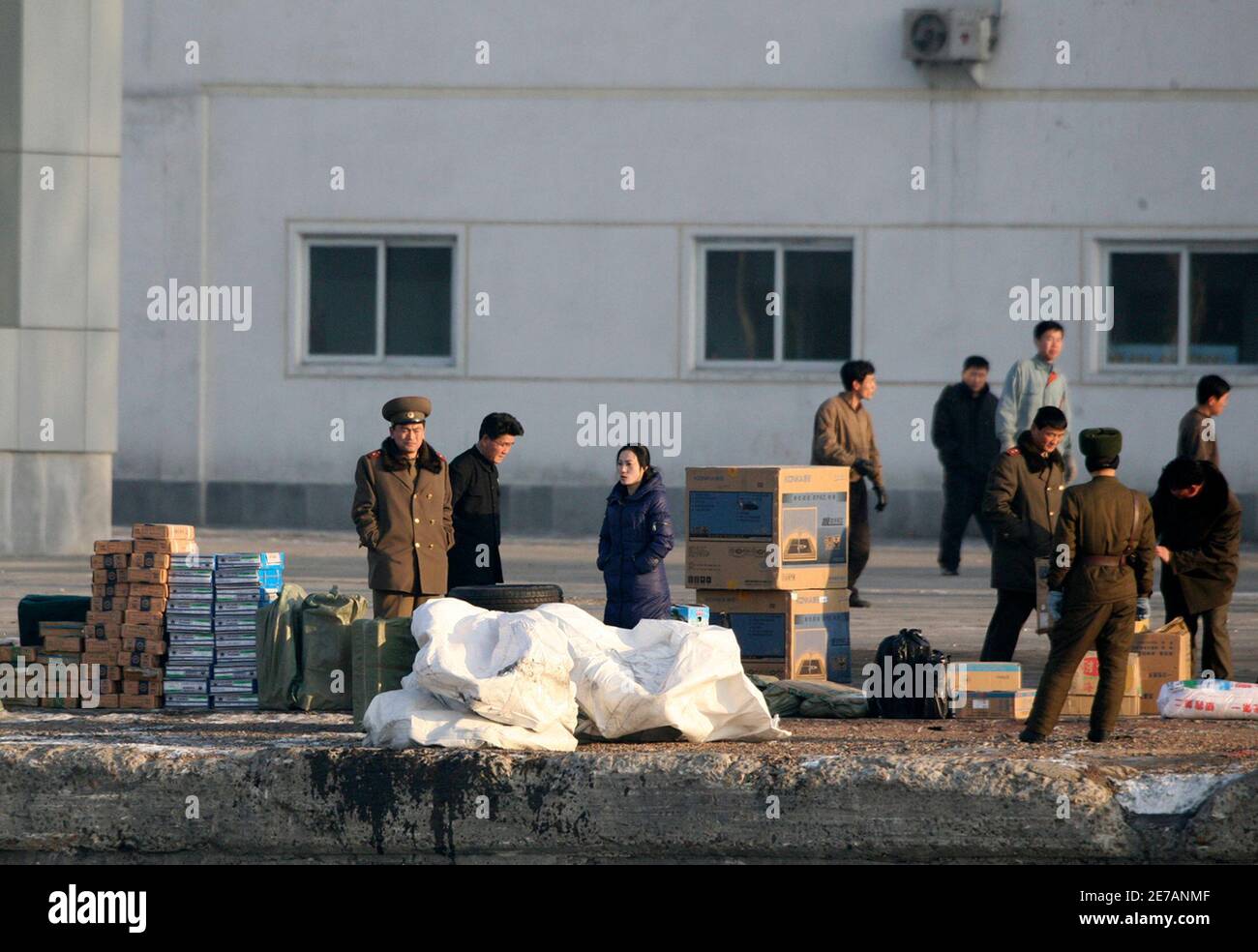 North Korean soldiers stand with goods transported from China on the banks of Yalu River near the North Korean town of Sinuiju, opposite the Chinese border city of Dandong January 8, 2010. North Korea on Tuesday shut a customs house in the northwest part of the country near the Chinese border city of Dandong, closing the region, and sent police to reinforce the rail link, Japan's Nihon Keizai newspaper reported, indicating leader Kim Jong-il may be about to visit his neighbour and biggest benefactor, a report said on Wednesday. REUTERS/Jacky Chen (NORTH KOREA - Tags: POLITICS MILITARY) Stock Photo