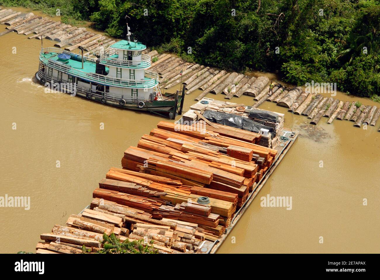 A boat pulls a raft carrying illegally logged timber, which has been  confiscated, along the Guamá River in the northeastern state of Para April  14, 2010. Brazilian Federal Police, IBAMA (Brazilian Institute