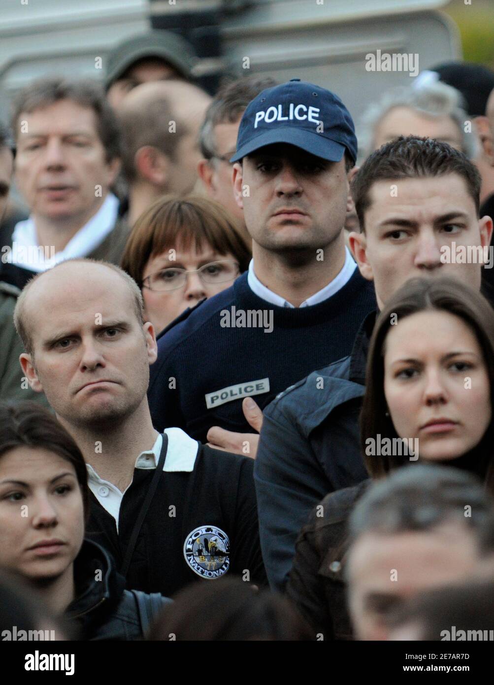 Friends, colleagues and relatives of slain French police officer Jean-Serge  Nerin gather in his memory in Dammarie-les-Lys, near Paris March 17, 2010.  A French police officer was shot and killed on Tuesday