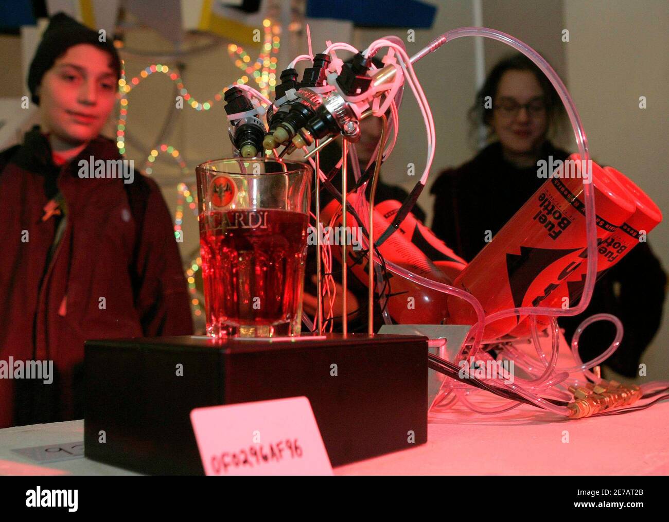 Visitors look at "The External Combustion Engine" December 7, 2006, made by Jacob Appelbaum, David Fine and Jonathan Moore of the U.S., one of around 30 robots at Vienna's annual Roboexotica, which showcases how home-built machines deal with the modern pastime of hanging out in bars. Picture taken December 7, 2006. TO ACCOMPANY STORY AUSTRIA-ROBOTS/ REUTERS/Herwig Prammer (AUSTRIA) Stock Photo