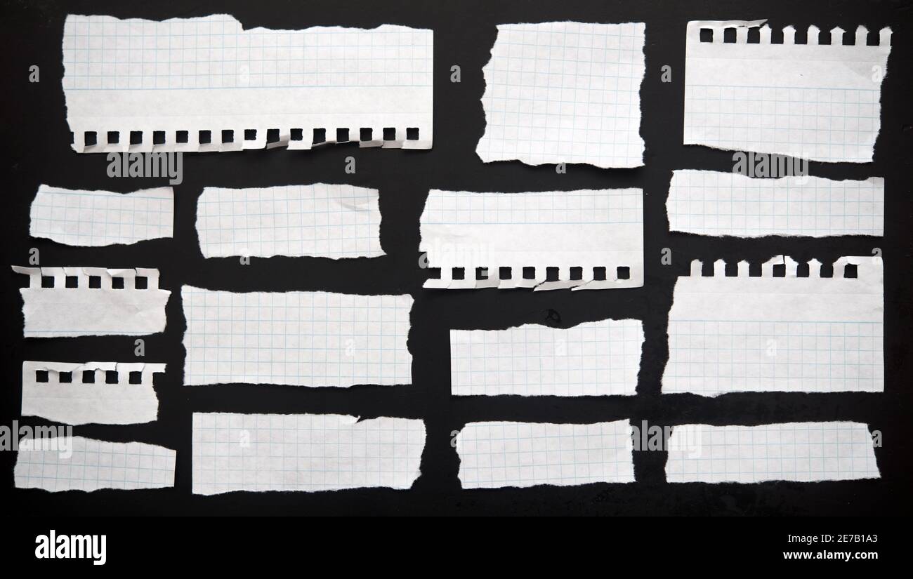 Torn papers on a black background Stock Photo
