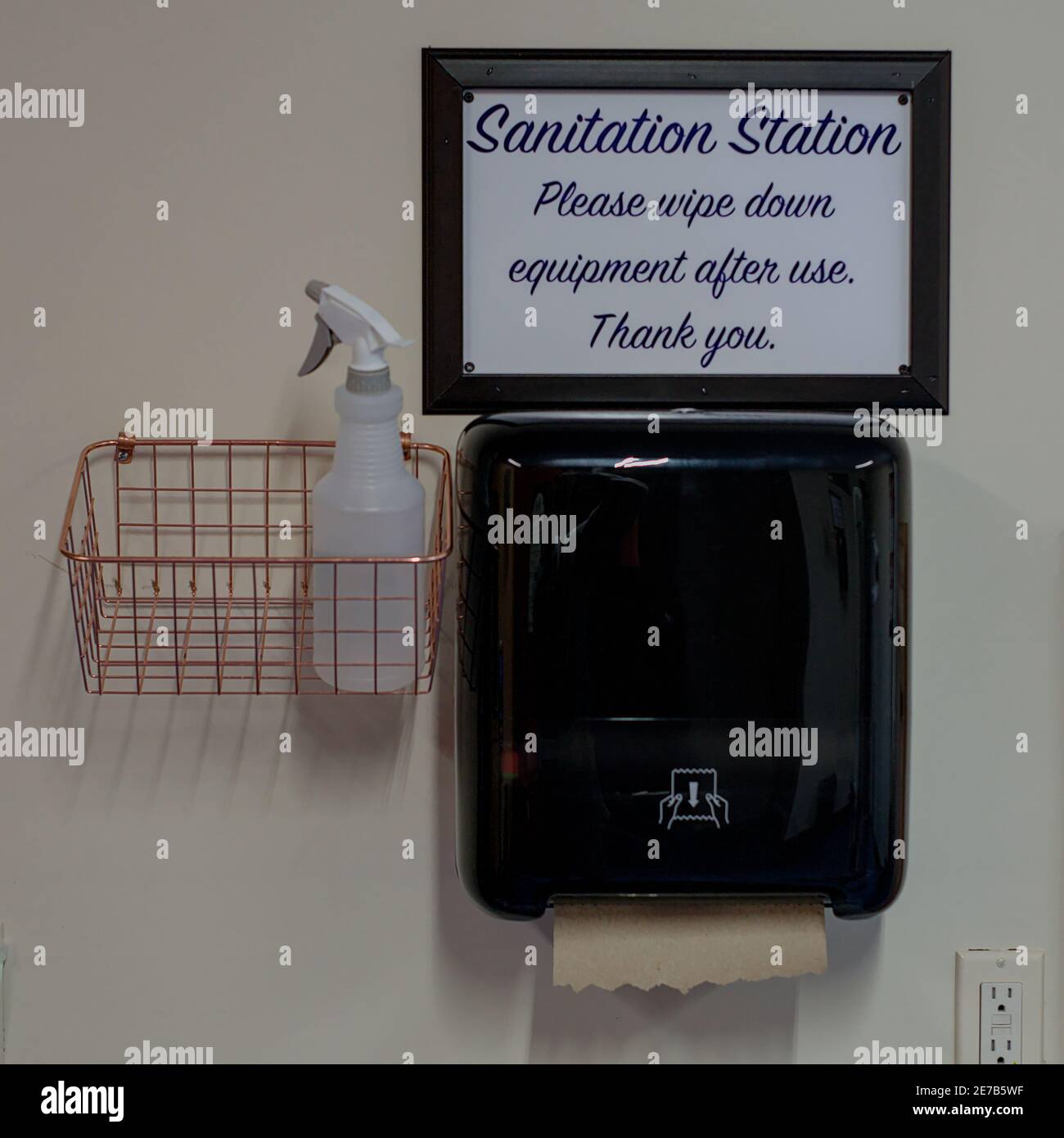 Gym station with alcohol spray bottle and paper towel dispenser and