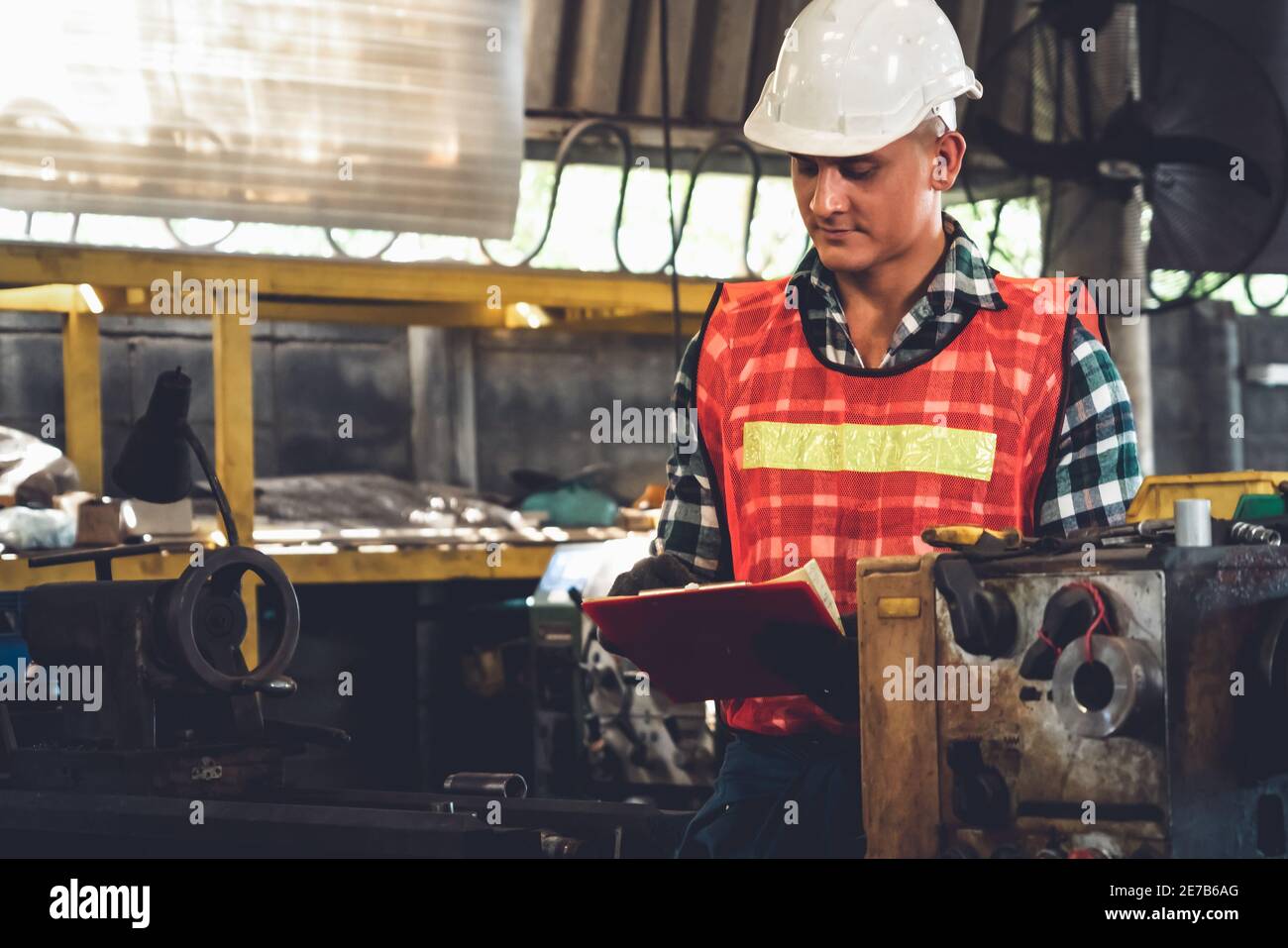 Manufacturing worker working with clipboard to do job procedure