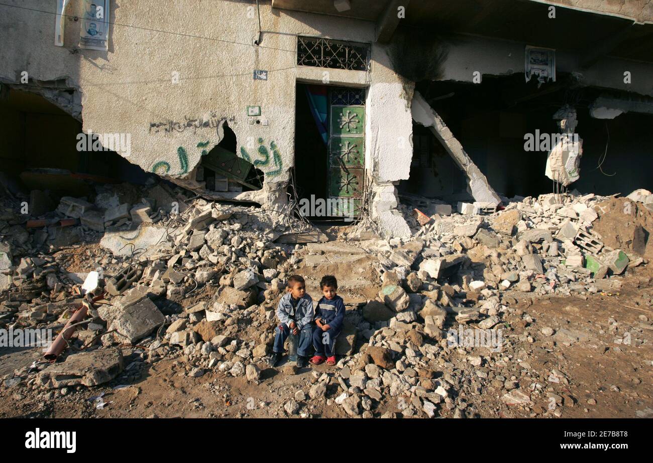 Palestinian boys sit outside their family's destroyed house after ...