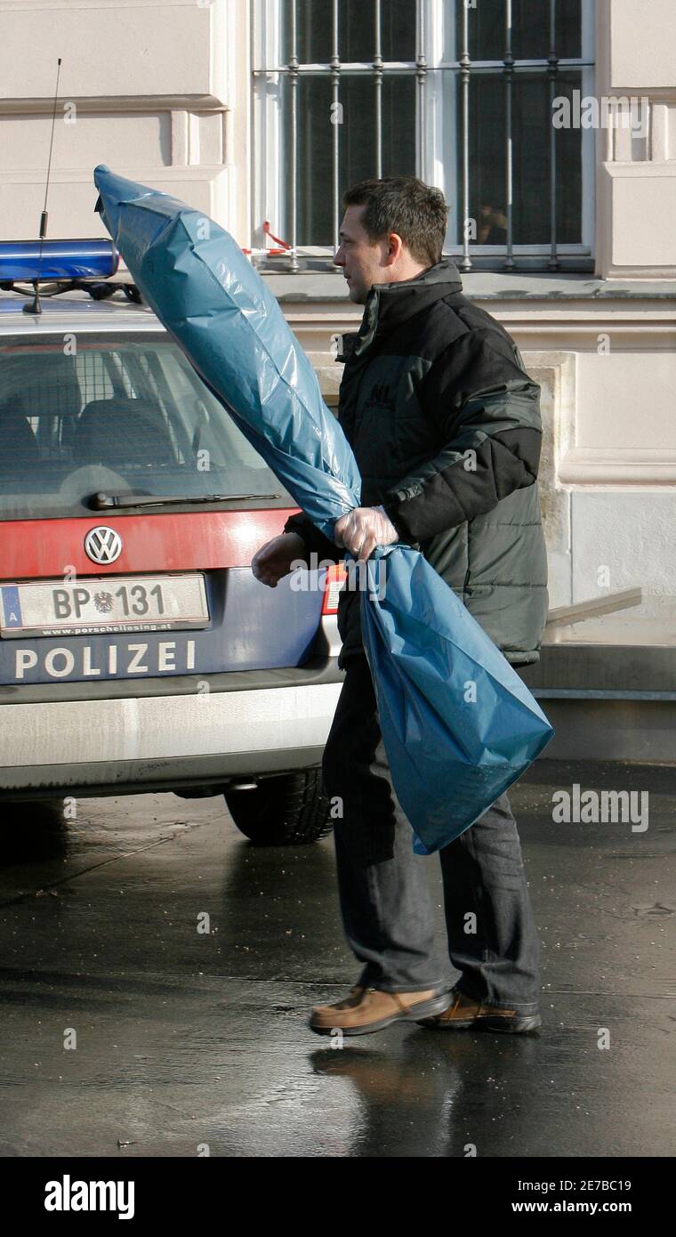 A police officer carries a bow rake wrapped in a plastic bag at Albertina  place next to Albertina museum in Vienna January 12, 2008. A cleaning woman  found the corpse of an