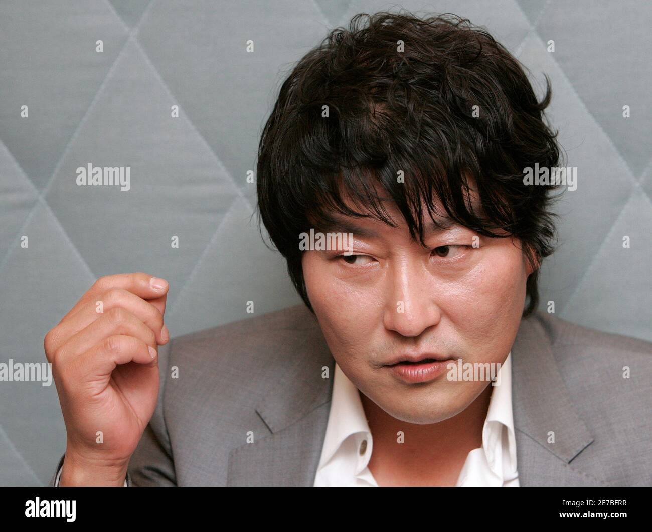 South Korean movie actor Song Kang-ho speaks during an interview with Reuters regarding his new movie 'Thirst', one of the 62nd Cannes Film Festival nominees, in Seoul May 4, 2009. One of South Korea's most bankable stars will return to the red carpet of the Cannes International Film Festival next week with a blood-soaked morality tale of a Catholic priest turned vampire.  Picture taken May 4, 2009.  REUTERS/Jo Yong-Hak (SOUTH KOREA ENTERTAINMENT HEADSHOT SOCIETY) Stock Photo