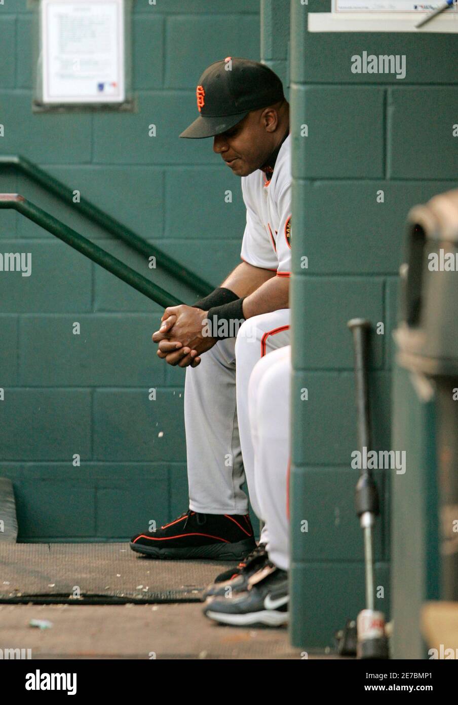 San Francisco Giants Barry Bonds sits in the dugout during the 1st inning of National League baseball action against Houston Astros in Houston, May 17, 2006. Bonds was not in the lineup for the game. REUTERS/Rick Wilking Stock Photo
