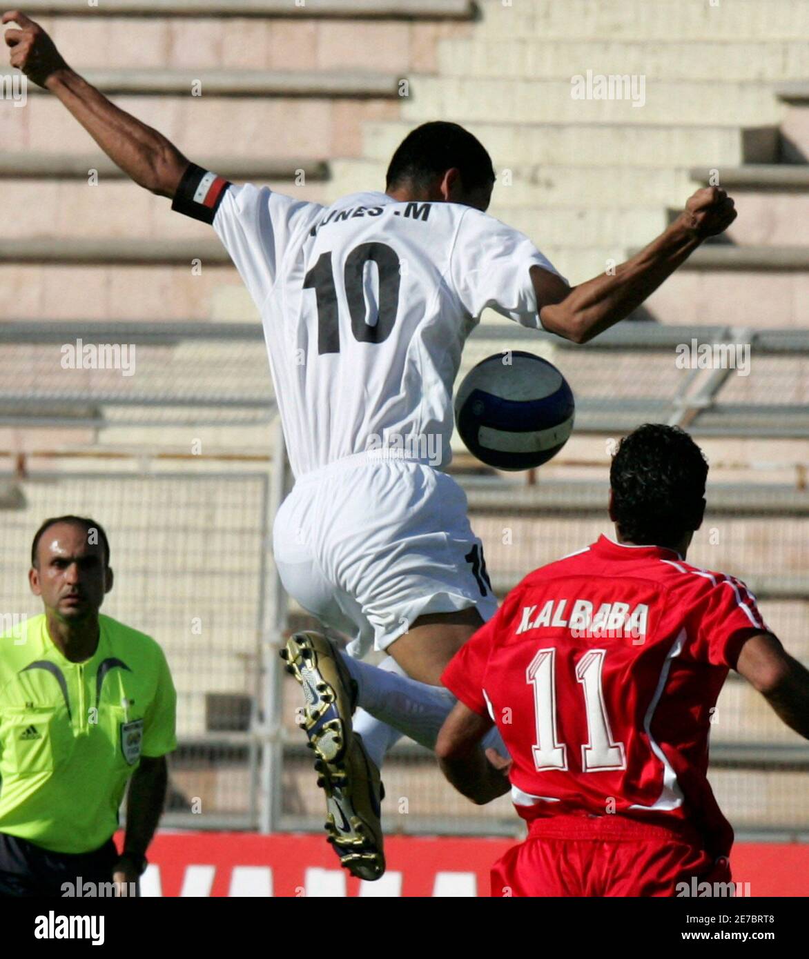 Iraq's Younes Khalef (L) jumps for the ball with Syria's Khaled Al Baba  during their West Asian Football Federation Championship soccer match at  Amman International Stadium June 22, 2007. REUTERS/Muhammad Hamed (JORDAN