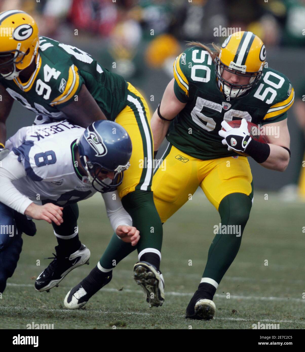 Green Bay Packers linebacker A.J. Hawk (50) runs an interception back as  Seattle Seahawks quarterback Matt Hasselbeck (8) is blocked by defensive end  Jarius Wynn (94) in the first quarter as the