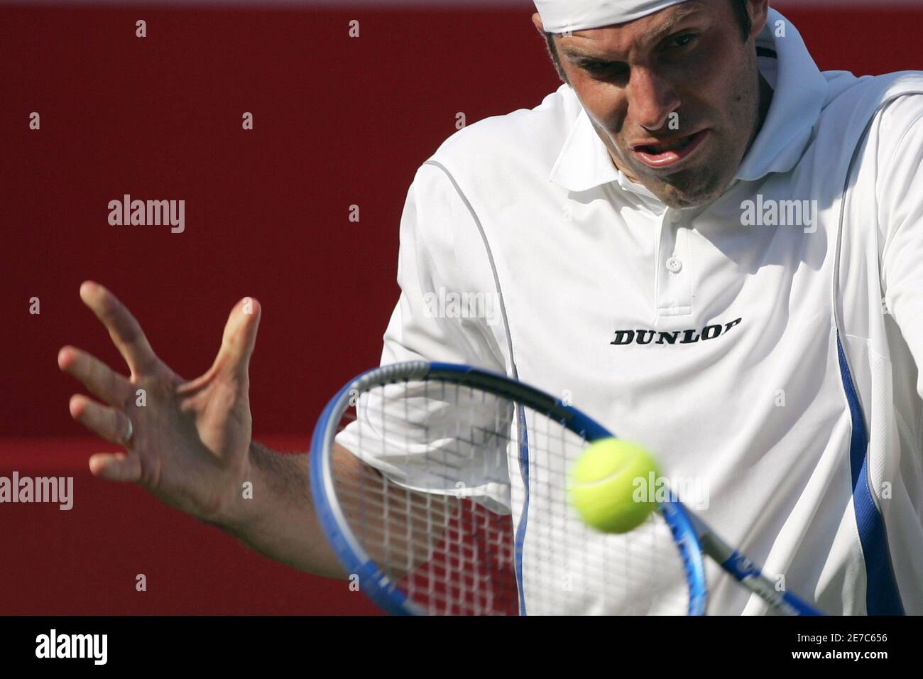 Britain's Greg Rusedski hits a return to Anthony Dupuis of France during  their match at the Stella Artois Championship tennis tournament at the  Queen's Club in London June 12, 2006. REUTERS/Luke MacGregor (