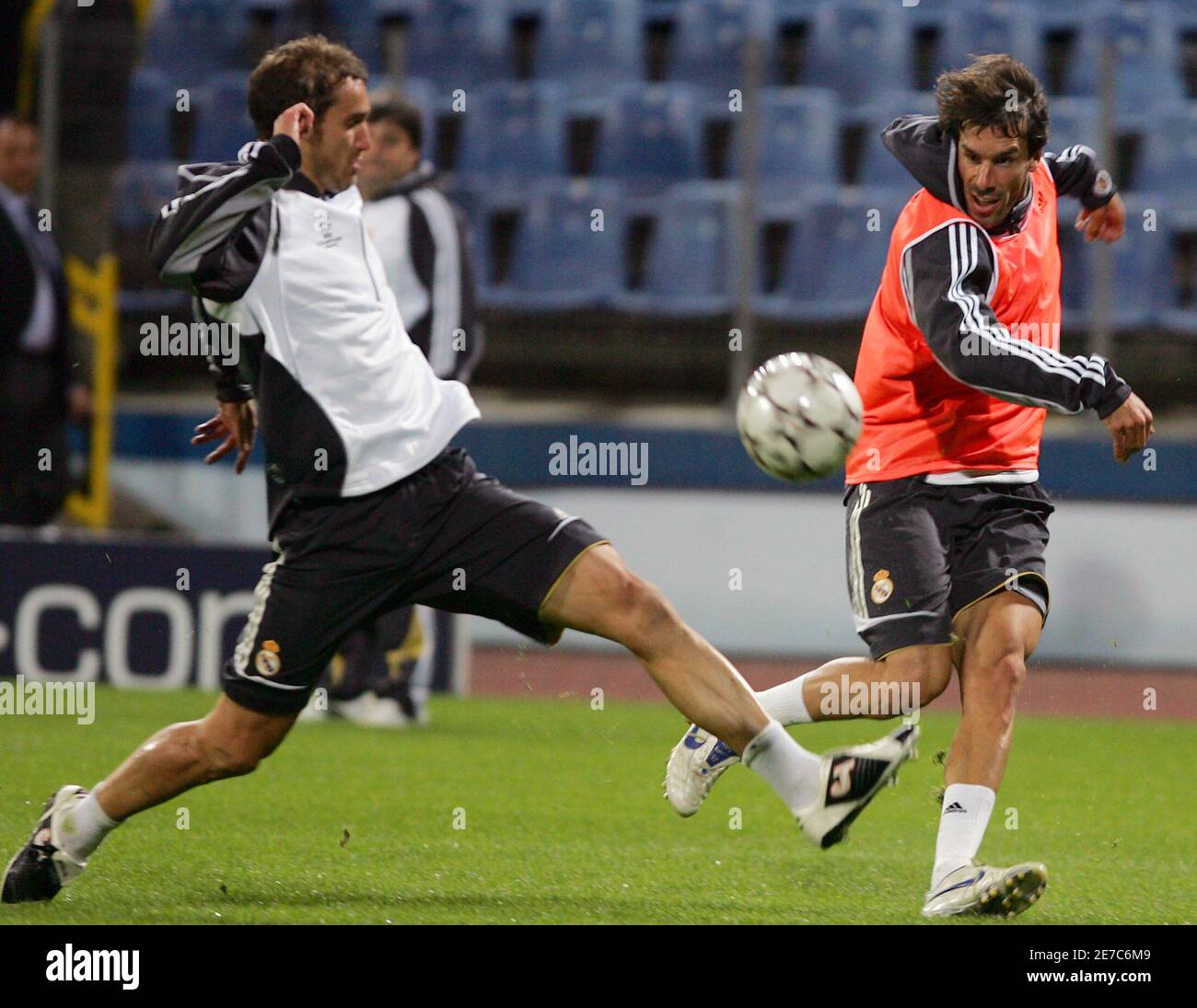 Real Madrid's Ivan Helguera (L) fights for the ball with Ruud van  Nistelrooy during their team's official training session, ahead of their  UEFA Champions League Group E soccer match against Steaua Bucharest,