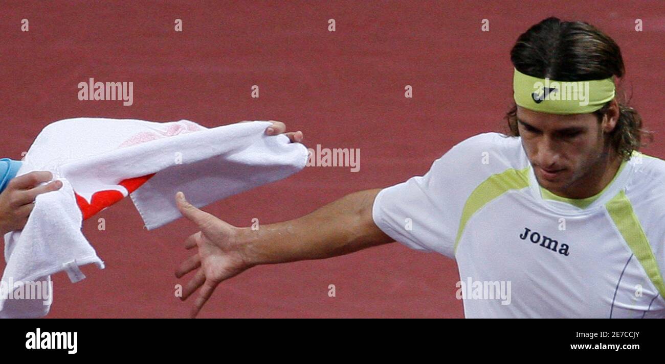 Spain's Feliciano Lopez takes a towel during his semifinal match against  Switzerland's Roger Federer at the Swiss Indoors ATP tennis tournament in  Basel October 25, 2008. REUTERS/Christian Hartmann (SWITZERLAND Stock Photo  - Alamy