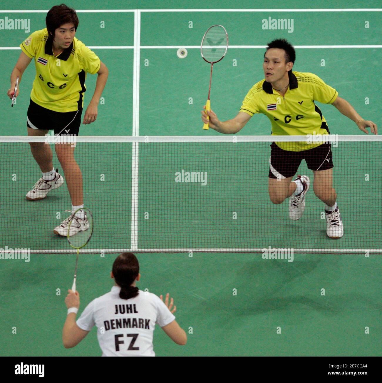 Thailand's Sudket Prapakamol returns the shuttlecock as his teammate  Saralee Thoungthongkam looks on during their match against Denmark's  Kamilla Rytter Juhl and Thomas Laybourn (not in picture) during the mixed  doubles semi