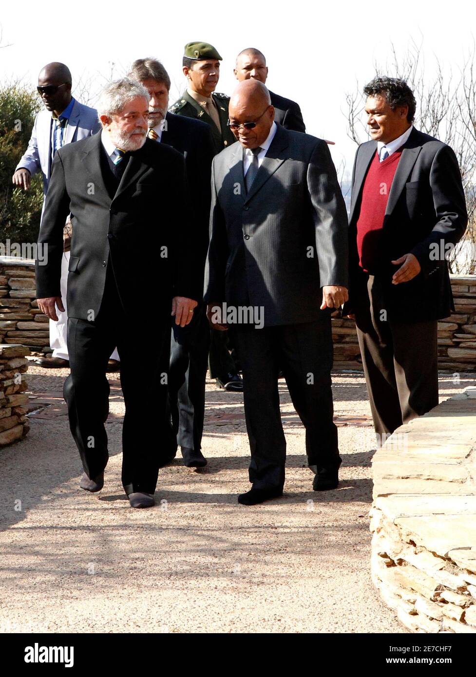 Brazil's President Luiz Inacio Lula Da Silva (L) and South Africa's President Jacob Zuma (2nd R) walk to pay respects at the Isivivane Memorial in the Freedom Park in Pretoria July 9, 2010. REUTERS/Thomas Mukoya (SOUTH AFRICA - Tags: SPORT SOCCER WORLD CUP) Stock Photo