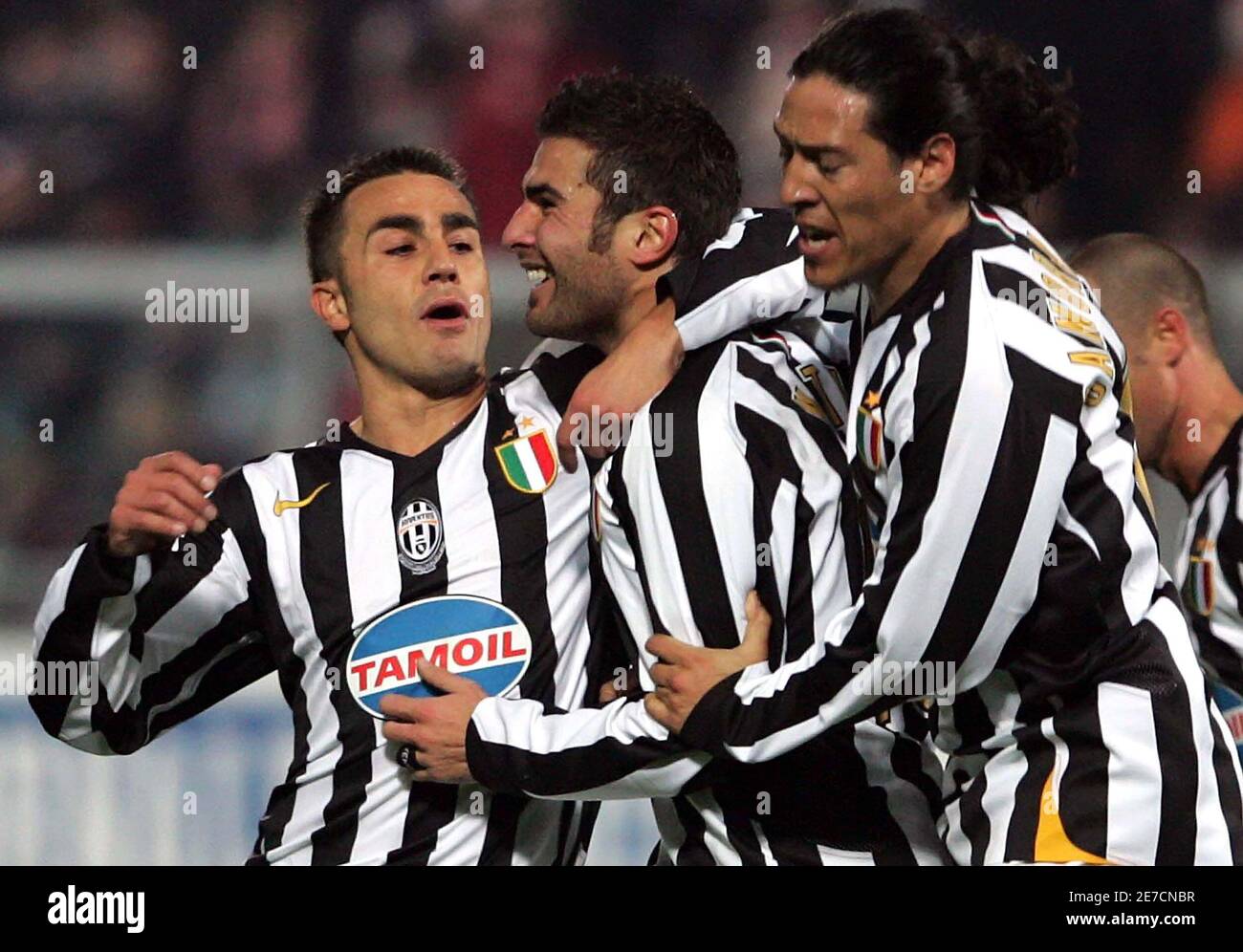 Juventus' Adrian Mutu (C) celebrates with his team mate Fabio Cannavaro (L)  and Mauro Camoranesi after scoring against Palermo during their Italian  Serie A soccer match in Palermo January 7, 2006. REUTERS/Antonio